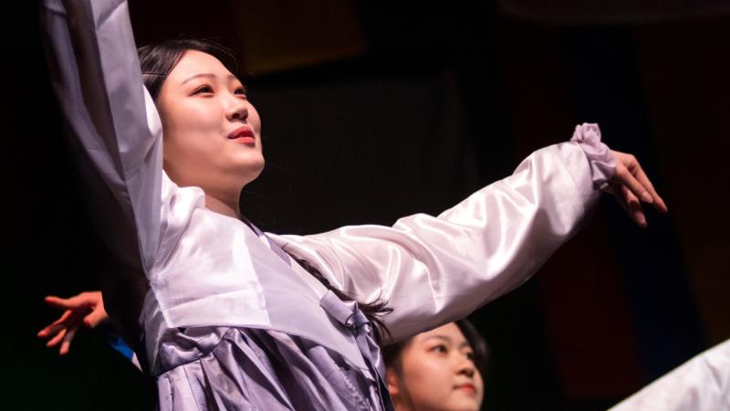 Asian students dancing in traditional attire during Cabaret