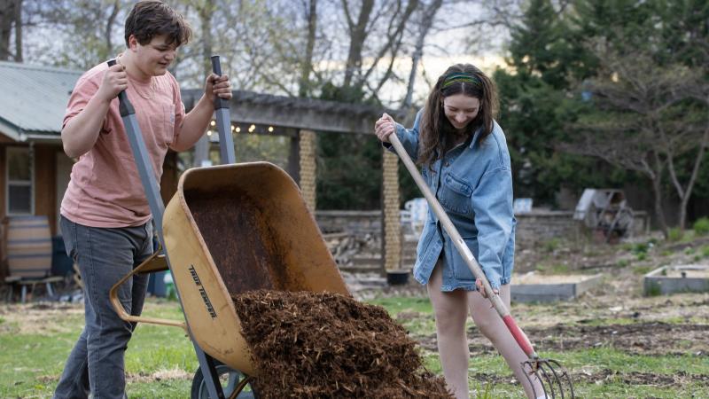 Anders Hanhan and another student spread mulch in SLUG.