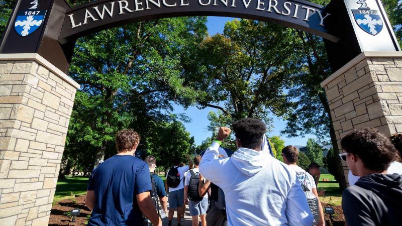 Students walking through arch