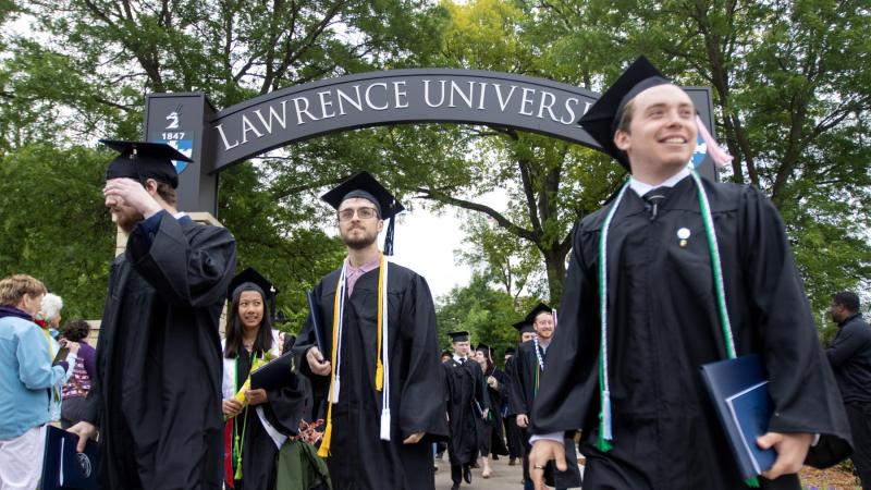 Graduates walk through the Lawrence Arch at the close of Commencement.