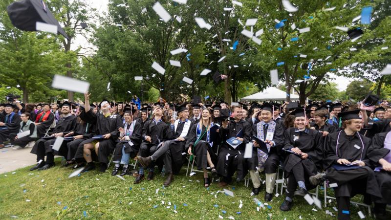 Confetti and hats fly among the graduates at close of Commencement.