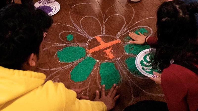 Students make rangoli art for Holi