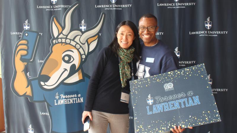 Jiayi Ling Young '94 and Tracy Donald '95 pose with Forever a Lawrentian signs.