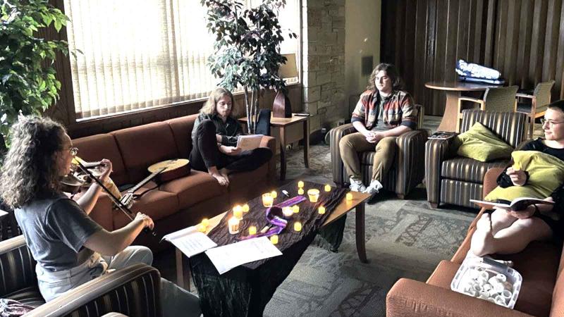 Students playing music with candelights