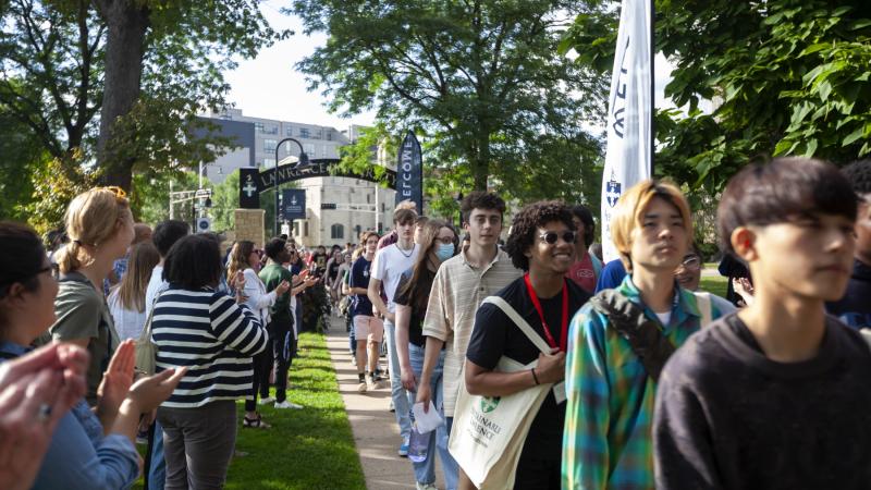 New students are greeted with applause as they process through the arch on the way to the President's Welcome in September 2022.