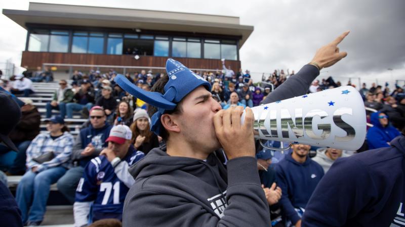 Nicolas Manzanera, a sophomore, cheers on the football team during Blue & White Homecoming Weekend at Banta Bowl.