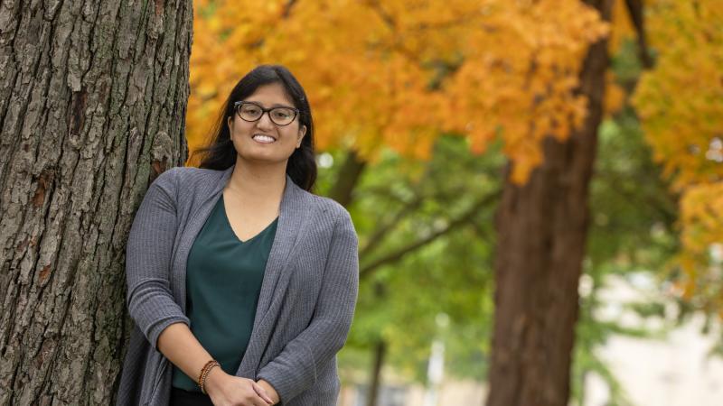 Marcy Quiason poses for a portrait amid fall colors on Main Hall Green.