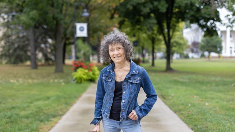 Catherine Kautsky stands on the sidewalk on Main Hall Green.