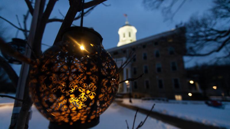 Photo of lantern in winter scene with Main Hall in the background.