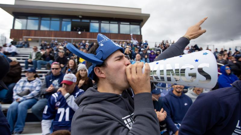 Nicolas Manzanera, a sophomore, cheers on the football team during Blue & White Homecoming Weekend.