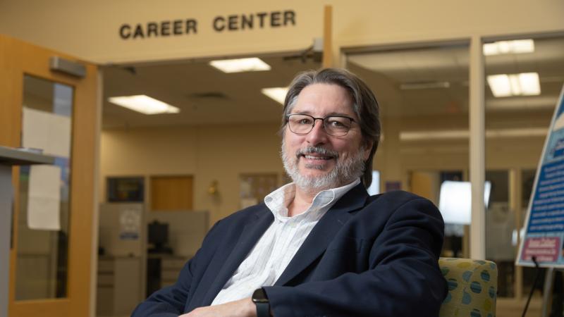 Kevin Gaw poses for a photo while sitting in the Career Center.