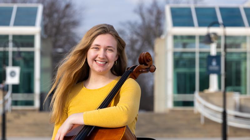 Annika Schmidt poses with her cello outside of the Music-Drama Center.