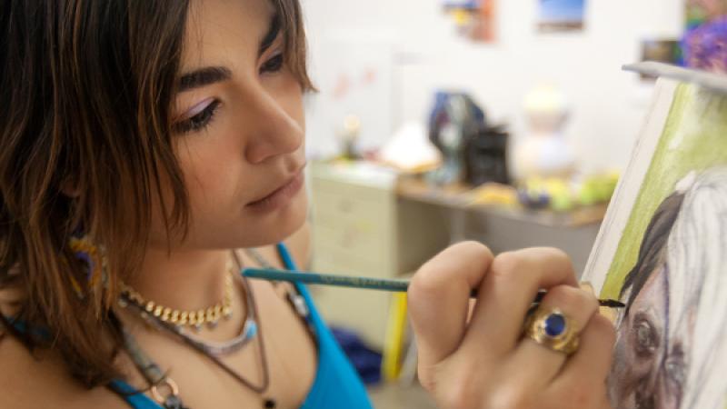 Marifé Entenza-Sierra, a studio art major, paints with acrylic paints. Students pursing an art degree are challenged to explore everything from water color to 3D digital animation.