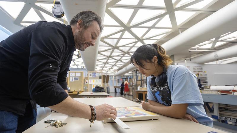 Studio art major student works with faculty member on scale in painting project in Wriston Art Center. Small class size matters. One-on-one faculty-student relationships ensure student engagement.