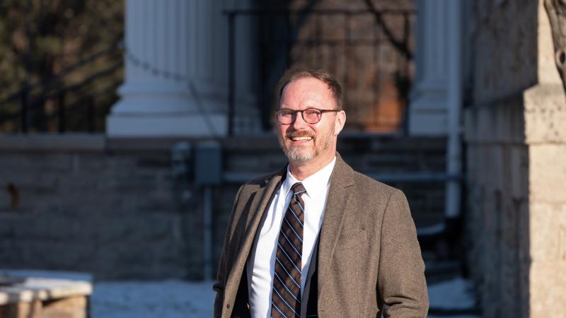 Portrait of Garth Bond standing in front of Main Hall.