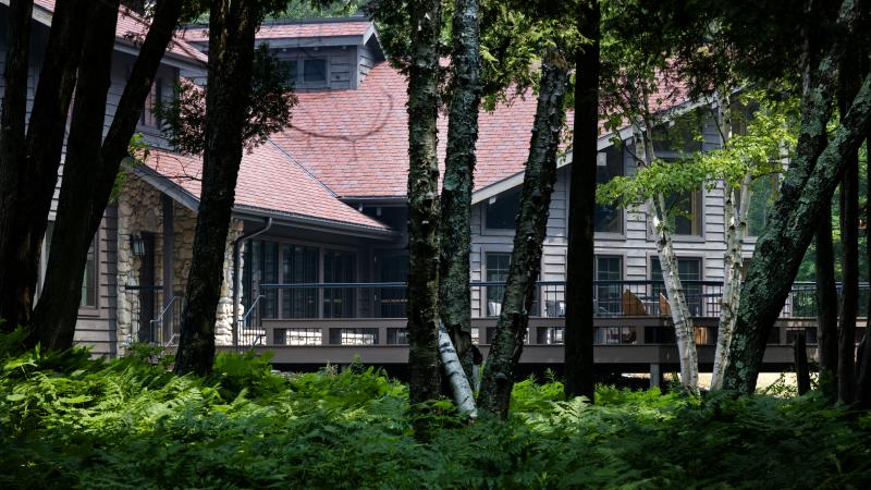 A photo of the Bjorklunden lodge taken through trees