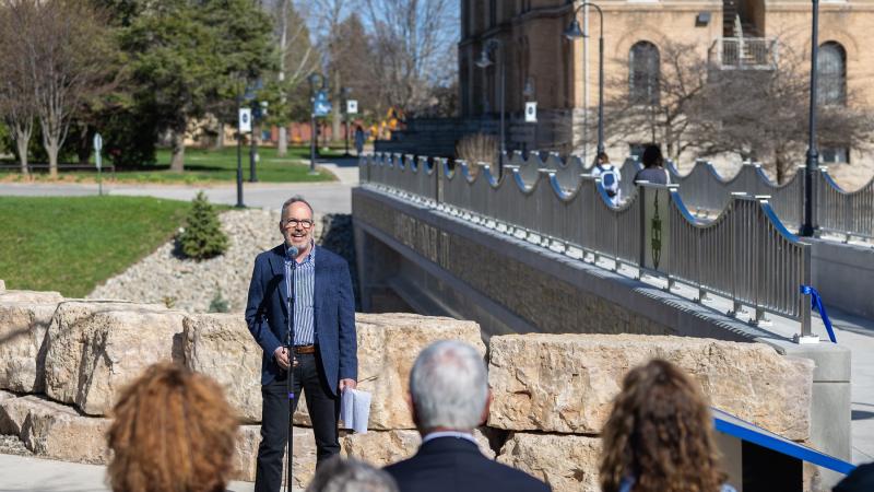 Mark Burstein speaks to those gathered for the dedication of the Calle Burstein Crossing.
