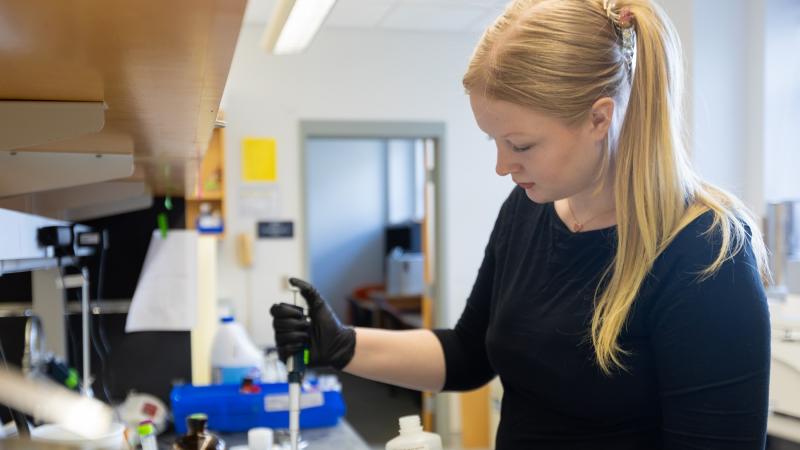 Lawrence University senior Charlie Bunch works in a science lab. 