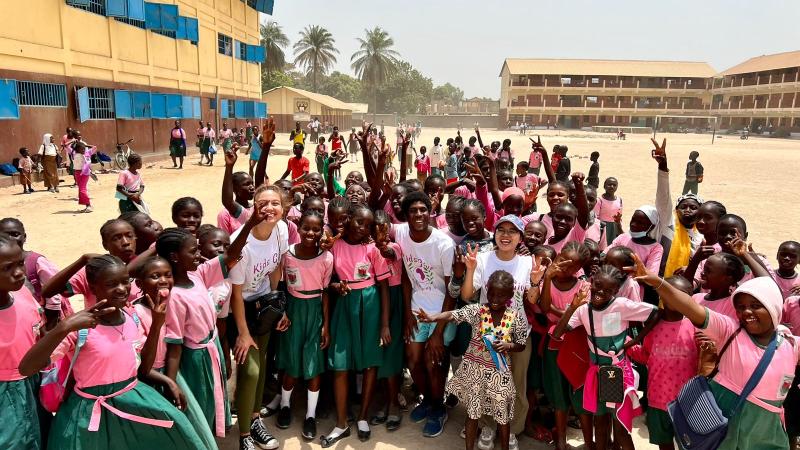 Lawrence students interact with students in a schoolyard in The Gambia.