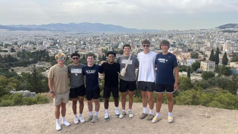 Lawrence basketball players pose for a photo while in Greece.