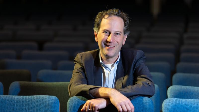Michael Mizrahi poses for a photo in the seats of Memorial Chapel.