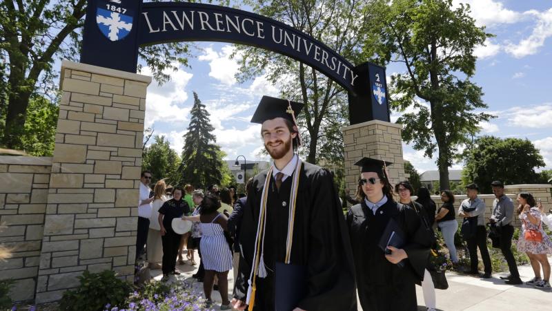 Graduates walk beneath the Lawrence Arch following 2024 Commencement.