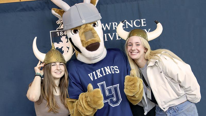 Two prospective students posing in viking helmets with Blu