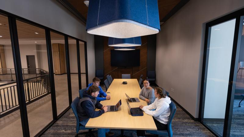 Business & Entrepreneurship Center Conference Room with students discussing a business pitch