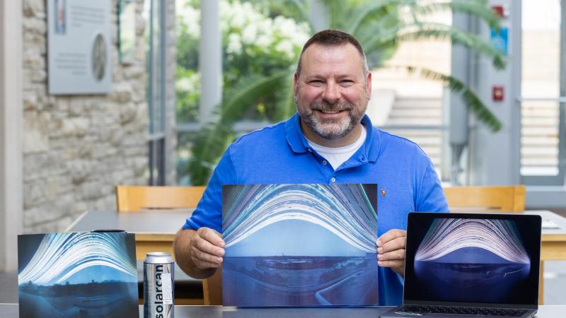 Brian Bartel ‘97 shows his Solarcan photos taken from rooftops on the Lawrence campus.
