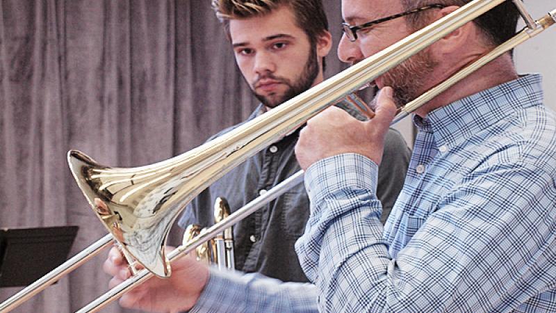 Trombone faculty member demonstrating technique to student