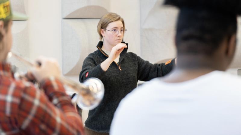 Trumpet studio faculty member conducting and students playing trumpet