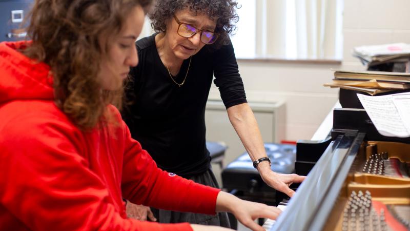 Student practicing on piano with Catherine Kautsky