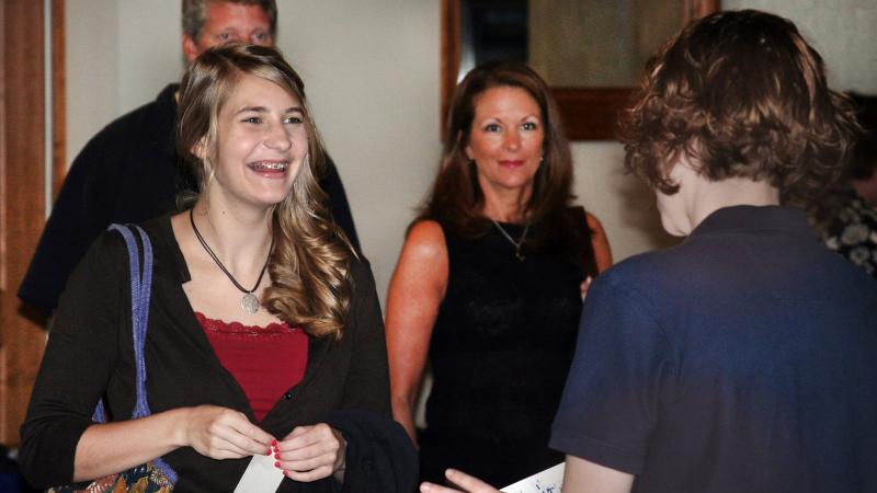 A prospective student and there parents meet with an admissions counselor for a campus visit.