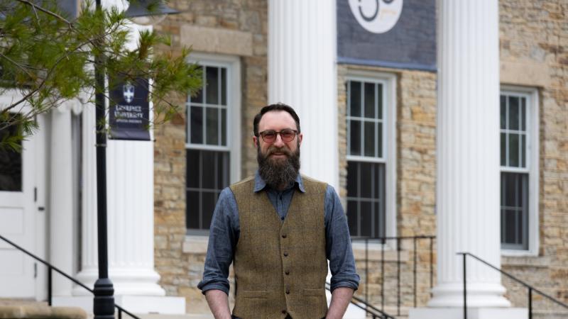 Kurt Wilson poses for a photo in front of Main Hall.