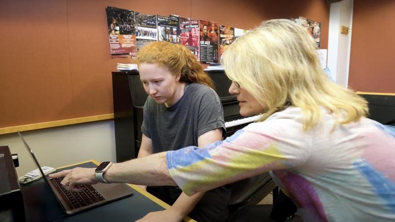 Patty Darling, music composition instructor and jazz ensemble director, works with music composition student on a composition.