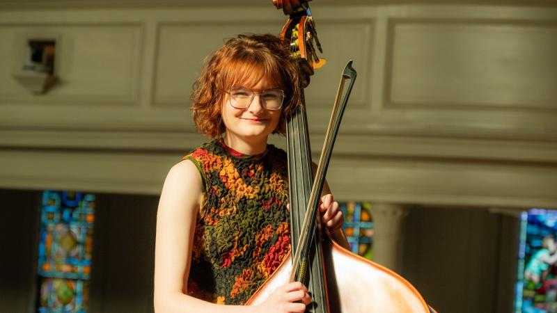 Vivian Shanley poses for a photo with her double bass.