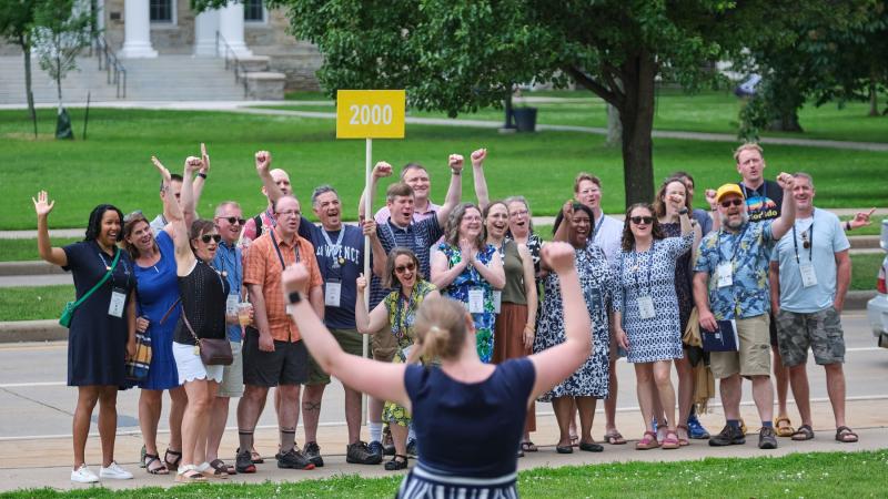 Alumni from the Class of 2000 are all smiles as they get their photo taken.
