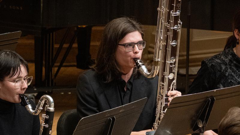 A couple of musicians playing bass and contrabass clarinets.