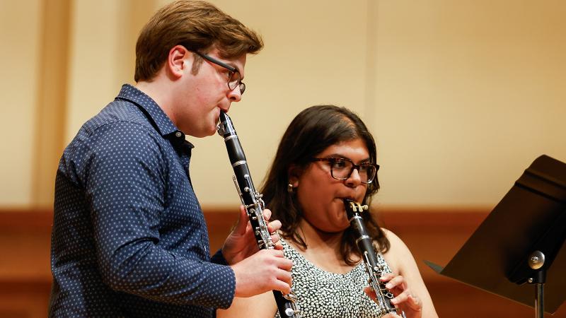 A duo of musicians playing clarinets.