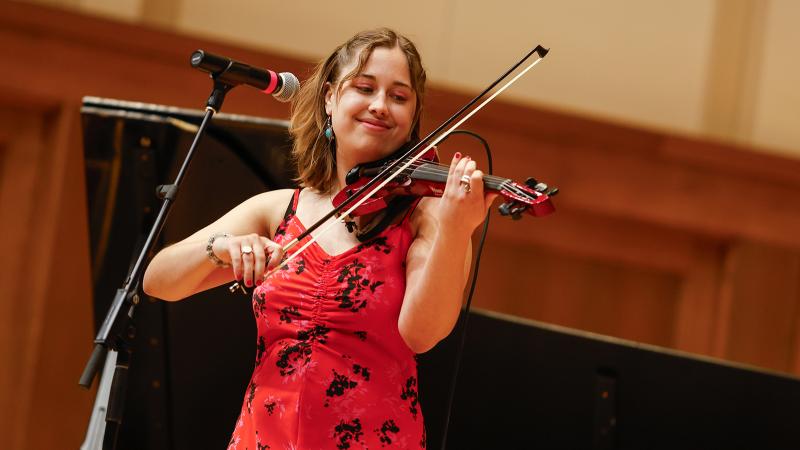 A musician playing an electric violin.
