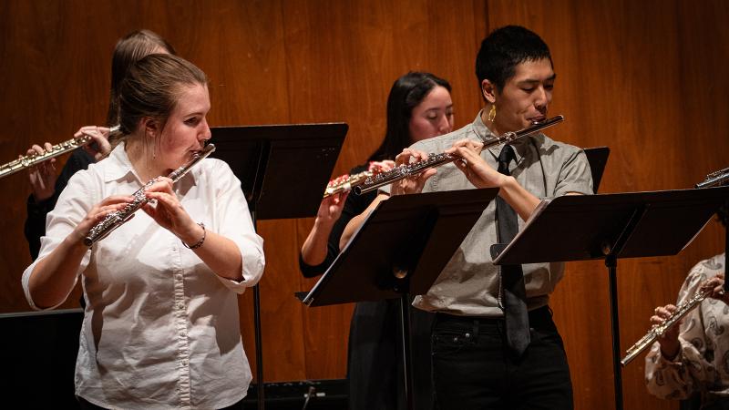 A small ensemble of musicians playing flutes.