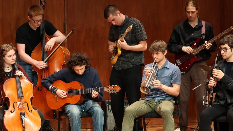 An ensemble of musicians playing various instruments.