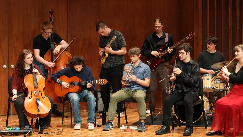 An ensemble of musicians playing various instruments.
