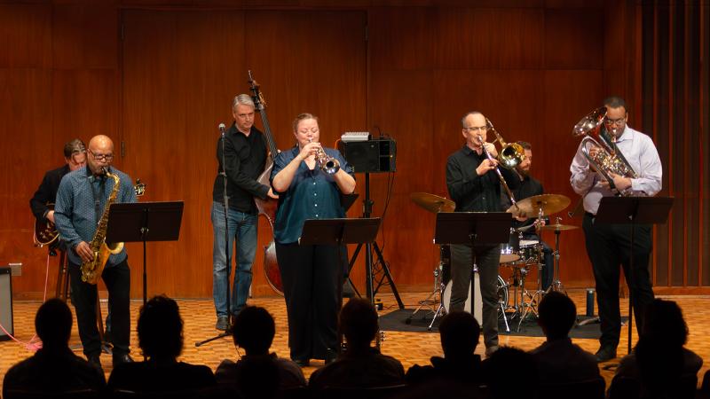 A group of jazz faculty playing various instruments in performance.