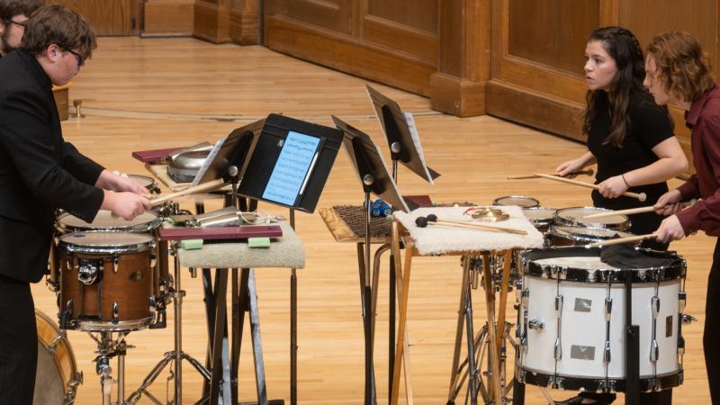 A quartet of musicians playing various percussion instruments.