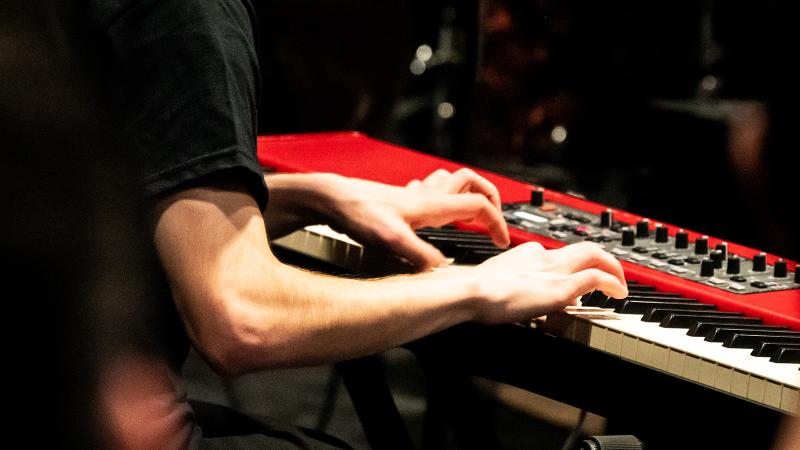 A musician playing Nord electric keyboard.