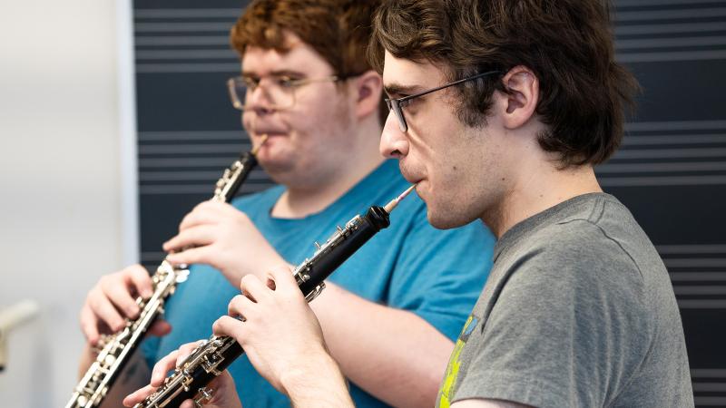 Two students playing oboes.