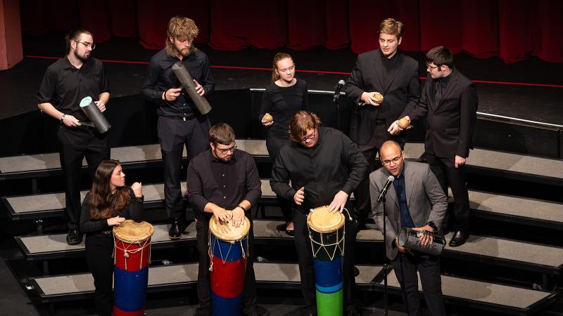 A small ensemble of musicians playing percussion instruments from the Dominican Republic.