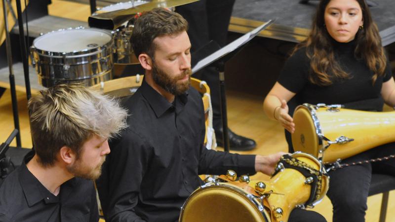 A trio of percussionists playing bata drums.