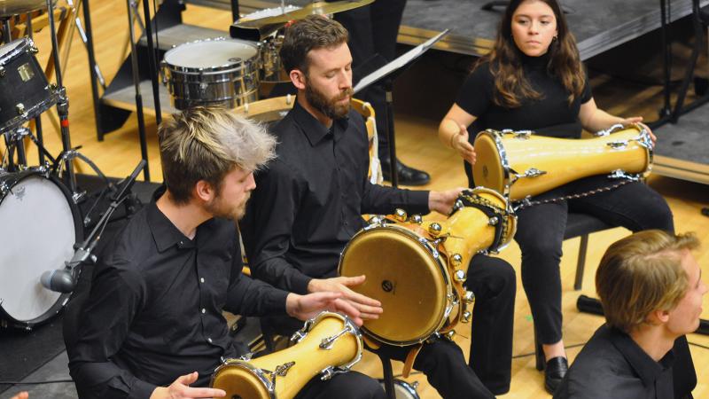 A trio of percussionists playing bata drums.